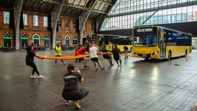 Salford Red Devils take on Bus Pull Challenge to help end homelessness